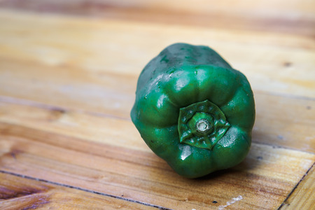 Green capsicum on wooden table background.Image with selective focus.の写真素材