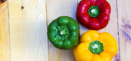 Colorful capsicum on wooden table background.Image with selective focus.