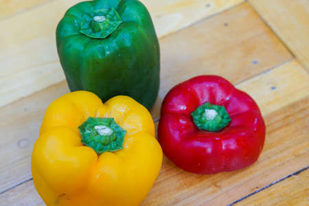 Colorful capsicum on wooden table background.Image with selective focus.の写真素材