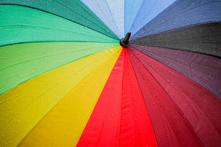 water drops after rains on colorful umbrellaの写真素材