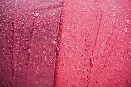 water drops after rains on colorful umbrellaの写真素材