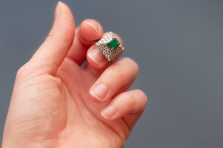Beautiful green emerald ring on finger