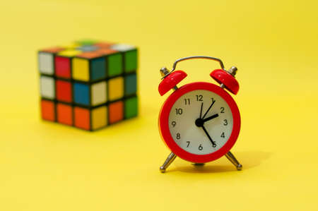 Rubik's Cube and Clock on yellowのeditorial素材