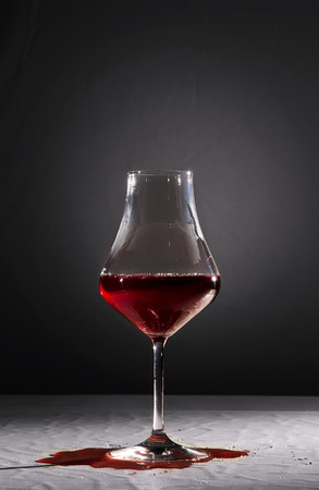 Wine incautiously poured into crystal goblet.の写真素材