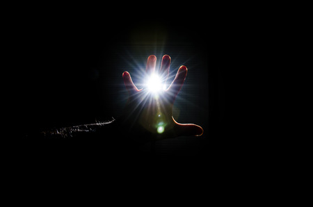 Hands protect against very bright flash of light.の写真素材