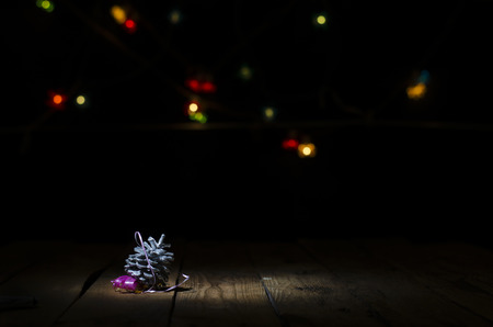 Christmas decorations on the rough wooden table against the background of garlands.の写真素材