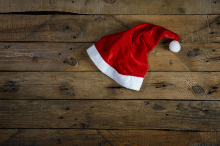 Hat of Santa Claus on a wooden table.の写真素材