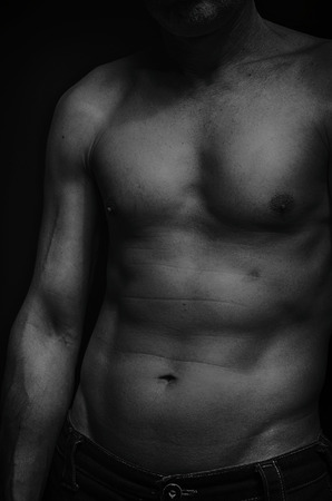 Torso of an elderly man in black and white.