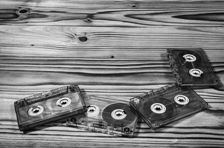 Audio cassette on a wooden table in black and white.の写真素材