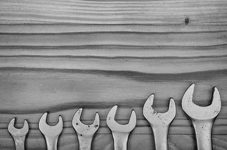 Wrenches on a wooden table in black and white.の写真素材