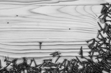 Screws on a wooden table in black and white.の写真素材