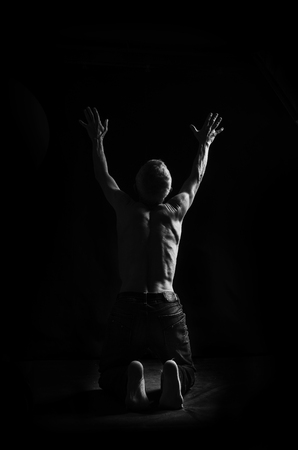 A man desperately asking for help from God, in black and white.の写真素材