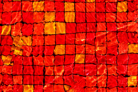 red mosaic rippled water in swimming poolの写真素材