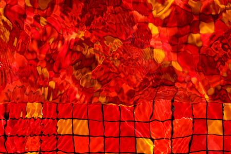 red mosaic rippled water in swimming poolの写真素材