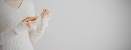 Soft focus young girl cheerful and using smartphone. Copy space. Successful, education, business and communication concept. Bannerの写真素材