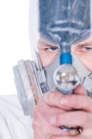 Man with airbrush gun, focus on face  の写真素材