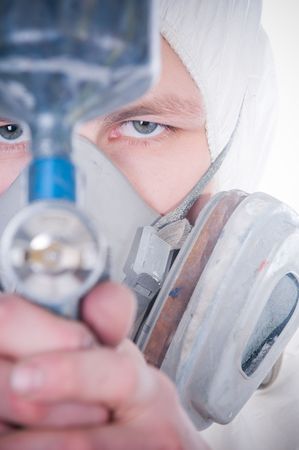 Worker with airbrush gun, selective focus on face  の写真素材