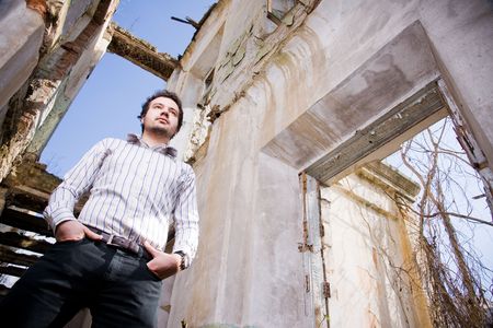 Young man in abandoned building, low angle of view の写真素材