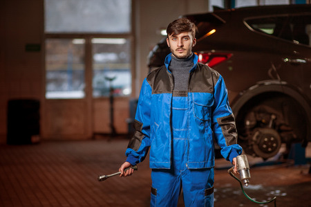 young handsome auto mechanic at workの写真素材