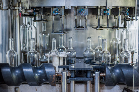 Wine bottles on the machine in production