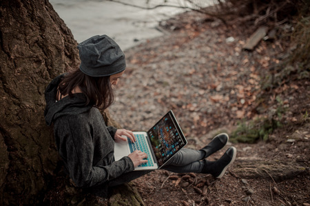 girl with a computer in nature