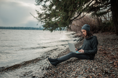 girl with a computer in natureの写真素材