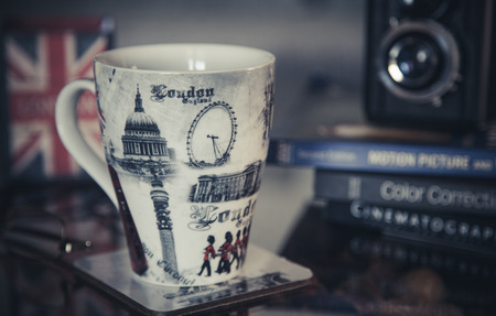 horizontal image london theme mug with books and film camera in backgroundの写真素材