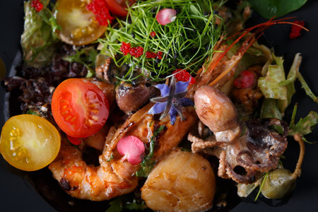 Seafood salad with shrimp, octopus and herbs, on a dark backgroundの写真素材