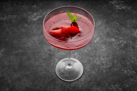 Strawberry panna cotta in a cocktail glass on a dark backgroundの写真素材