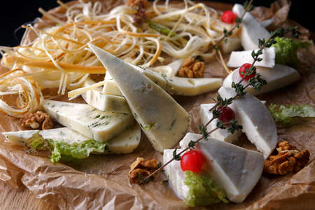 Sliced assorted cheese, mozzarella, camembert, brie, parmesanの写真素材