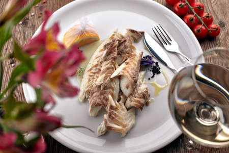 Fried Sibas fish on a white plateの写真素材