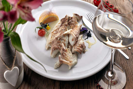 Fried Sibas fish on a white plateの写真素材