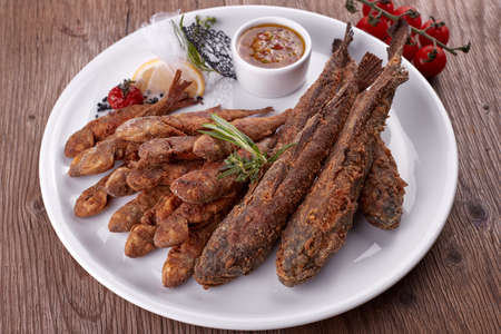 Fried fish on a white plate, on a board. Bulls, Barabolaの写真素材