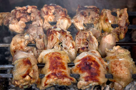 Chicken kebab, outdoors, on a homemade grill, close-upの写真素材