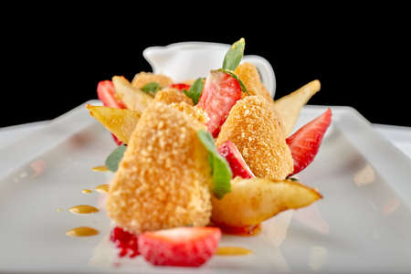 Cheese nuggets with strawberries on white backgroundの写真素材