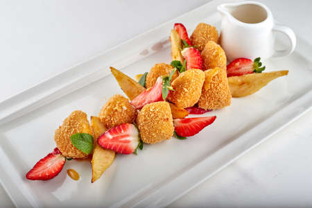 Cheese nuggets with strawberries on white backgroundの写真素材