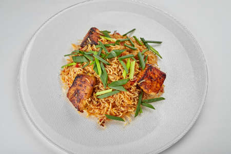 Pilaf with salmon on a white plateの写真素材