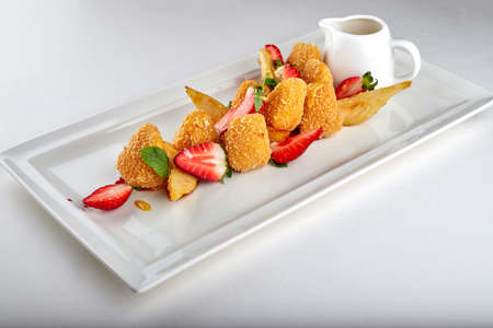 Cheese nuggets with strawberries on white backgroundの写真素材
