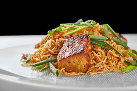 Pilaf with salmon on a white plateの写真素材