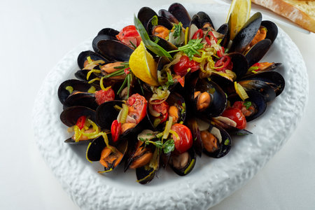 Mussels on a white plate on a white backgroundの写真素材