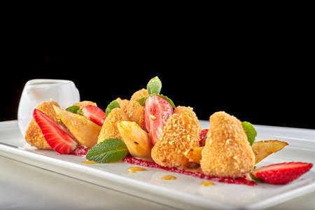 Cheese nuggets with strawberries on white backgroundの写真素材