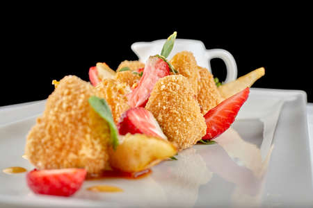 Cheese nuggets with strawberries on white backgroundの写真素材
