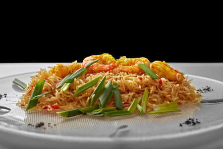 Pilaf with shrimp on a white plateの写真素材
