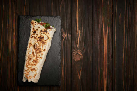 lula kebab with herbs on a wooden surface on the tableの写真素材