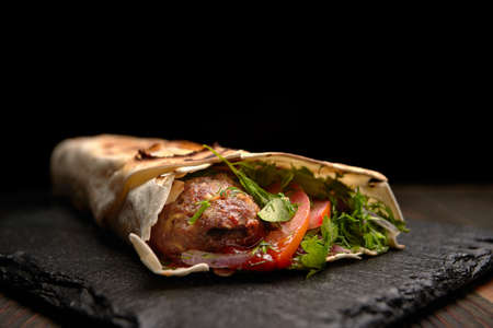 lula kebab with herbs on a wooden surface on the tableの写真素材