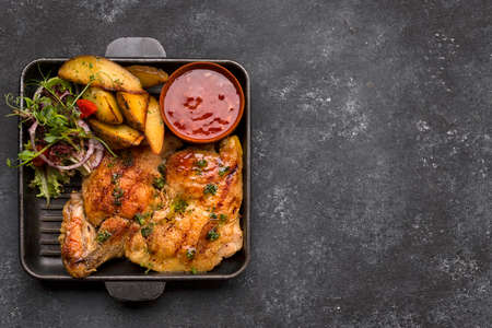 Fried chicken with crispy crust, potatoes and sauceの写真素材
