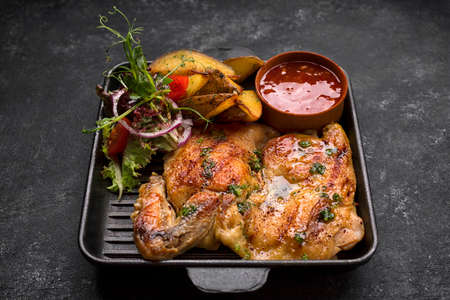 Fried chicken with crispy crust, potatoes and sauceの写真素材