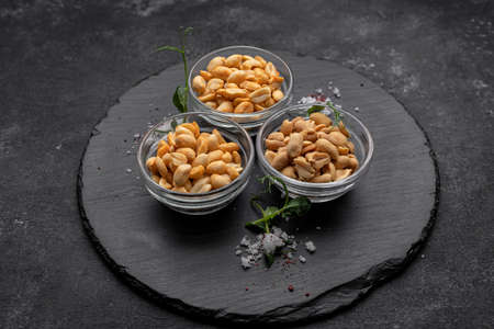 Roasted peanuts with salt, for beer, on a dark backgroundの写真素材