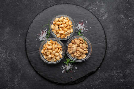 Roasted peanuts with salt, for beer, on a dark background
