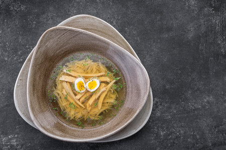 Childrens broth with chicken, eggs and noodlesの写真素材